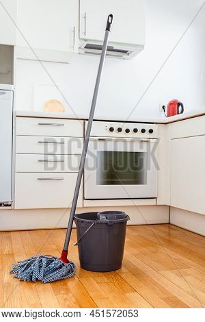 Cleaning Parquet Floor With Rope Mop. Microfiber Mop With Wringer And Bucket Of Water For Cleaning F