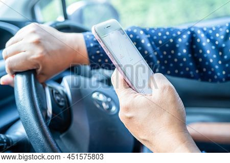 Bangkok, Thailand, July 1, 2021 Holding Iphone In Toyota Sienta Car To Communication With Family And