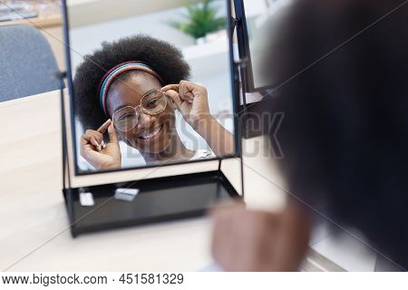 Close Up Mirror With Face Of Young Woman African American Afro Hair Wear Spectacles. Choosing Eyegla