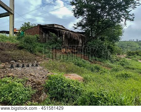 Stock Photo Of Old Style Red Brick House With Cement Roofing Sheet On Roof Top ,small Shelter In Fro