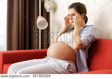 Young And Pregnant Woman Has Painful Headache