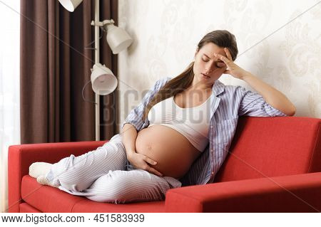 Young And Pregnant Woman Has Painful Headache