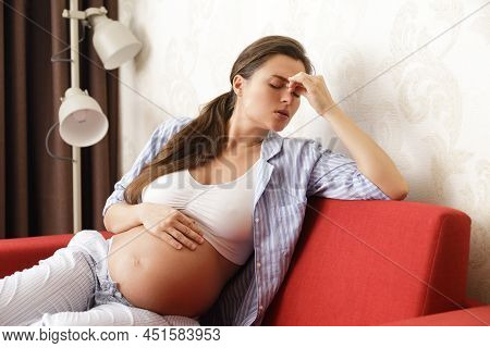 Young And Pregnant Woman Has Painful Headache