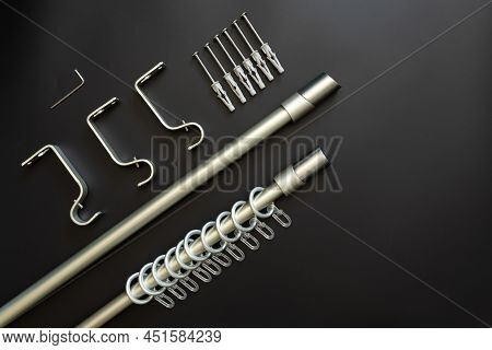 Curtain Rod With Fasteners, Rings And Hooks For Hanging Curtains On A Black Background. Package Cont