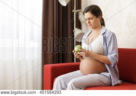 Young And Pregnant Woman At Home Feels Sick