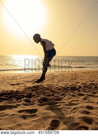 Saly, Mbour, Senegal - Circa December 2021. Unidentified Teenager Doing Sport Abdominal Musculation 