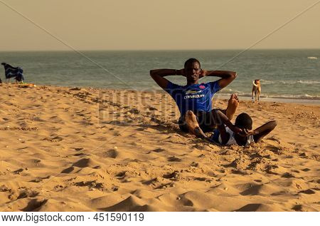 Saly, Mbour, Senegal - Circa December 2021. Unidentified Mature Man And Teenager, Father And Son, Do