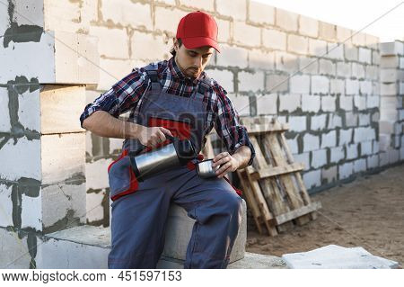 Bricklayer During The Coffee Break At The Work