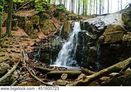 Waterfall In The Carpathian Mountains In A High Green Forest On A Spring Sunny Day