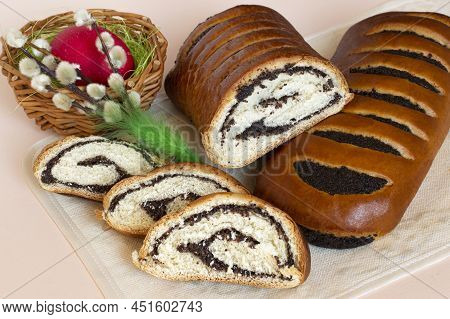 Delicious Easter Roll With Poppy Seeds (makowiec) Whole And Sliced. Traditional Polish Festive Pastr