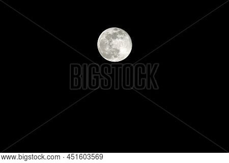 Very Large Bright Full Moon And Craters Clearly Visible In The Black Midnight Sky