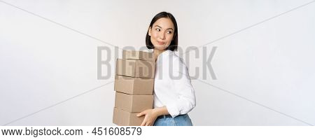 Portrait Of Young Asian Woman Holding Boxes, Carry Delivery Goods. Korean Female Entrepreneur Assemb