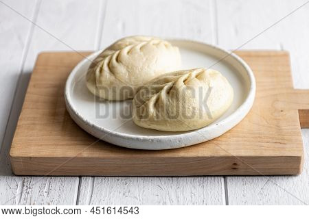 Traditional Korean Steamed Buns, Pyanse Or Pigodi, On White Wooden Background, Selective Focus
