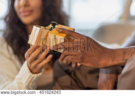 Moscow Russia-december 2021:a Happy Couple Of Mulattoes Exchange Gifts With Each Other. Celebrating 