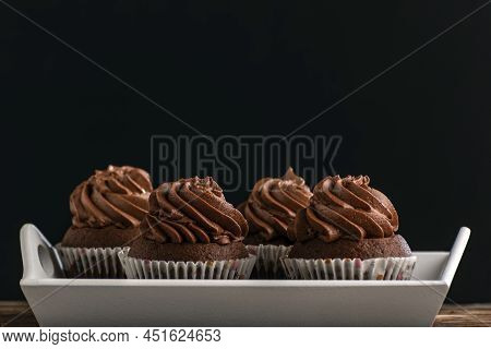 Chocolate Mafina With Cream On Tray On Black Background. Homemade Muckles. Side View. Close Up