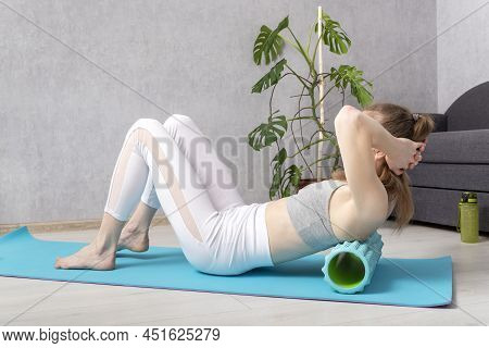 Active Girls Do Fitness Workout At Home And Massage Her Back With Foam Roller. Myofascial Roller