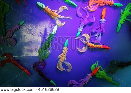 Silicone Bait For Catching Predatory Fish Is Painted With Phosphoric Paint. Demonstration Of Modern 