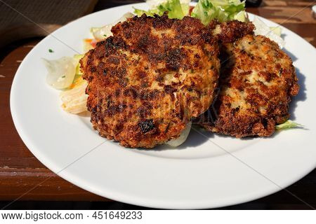 Traditional Tirolean Flat Bread Dumplings Kaspressknodel Filled With Mountain Cheese Served With Gre