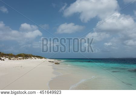 Turquoise Waves Lap Up On The Sandy Shore Of The Deserted Island Of Klein Bonaire Off Of Bonaire In 