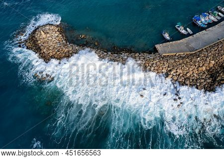 Aerial Drone View Of Fishing Boats Moored At The Harbor At Breakwater. Stormy Waves At Sea Peyia, Cy