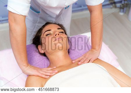 Facial Massage. A Woman Is Given A Massage In A Beauty Salon. Close-up.