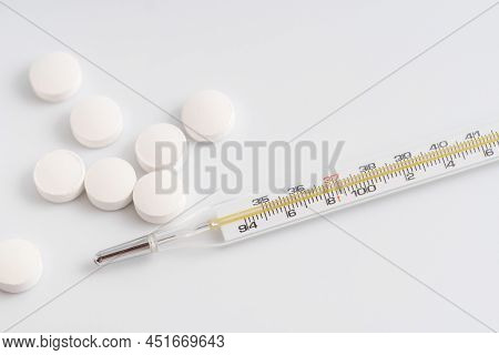 Close Up Of Thermometer And White Pills
