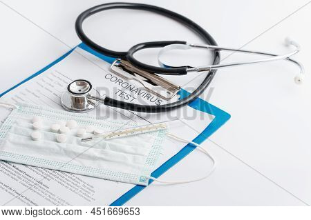 Stethoscope, Thermometer And Folder With Documents On The Table