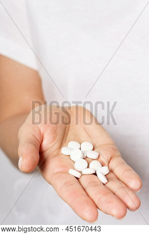 Female Hand With A Handful Of Pills