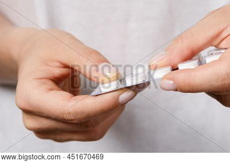 Female Hand With A Pill In Foil Packaging
