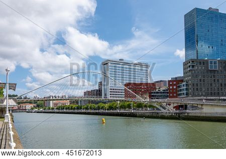 Bilbao, Spain - June 14, 2018:  View Of  The City On The Nervion River With The Zubizuri Bridge In T