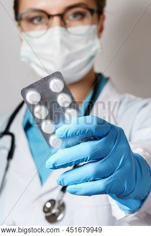 Female Doctor And Pills In Foil Packaging