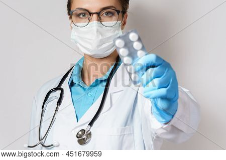 Female Doctor And Pills In Foil Packaging