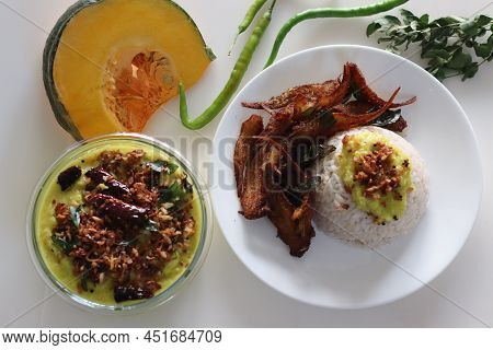 Kerala Meals With Boiled Matta Red Rice, Coconut Based Pumpkin Curry And Anchovy Fry