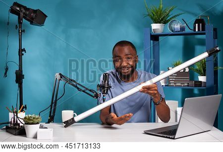 Portrait Of Videographer Reviewer Presenting Rgb Tube Light Used For Recording Video In Vlogging Stu