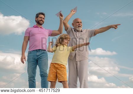 Fathers Day. Kid Having Fun With Toy Paper Plane. Men Generation Family With Three Different Generat