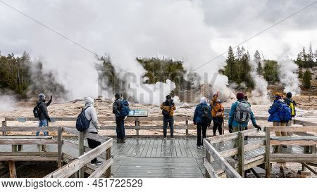 Wyoming, Usa - October 1, 2019: Tourists On Wooden Bridge On Hot Zone Inside Yellowstone National Pa