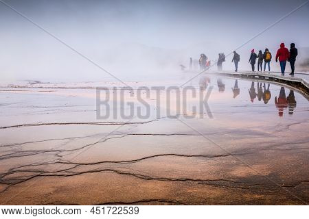 Wyoming, Usa - October 1, 2019: Misty Scene Of Walking Tourists On Wooden Boardwalk Inside Orange We