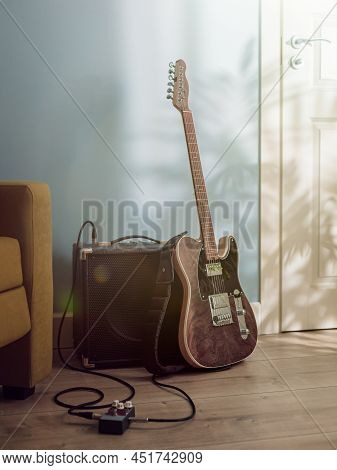 Electric Guitar And Amplifier Standing On The Floor Between Sofa And Door In Sunlight From The Windo