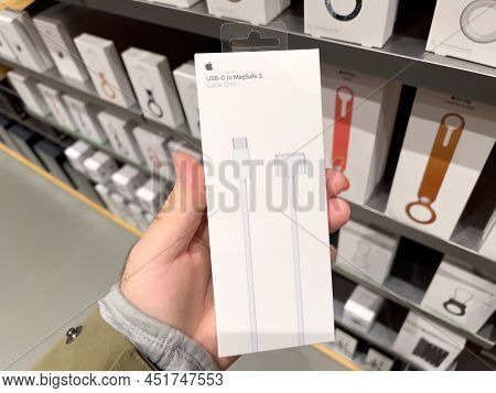 Paris, France - Mar 18, 2022: Pov Male Hand Holding Package Wtih Usb-c To Magsafe 3 2 Meters Cable D