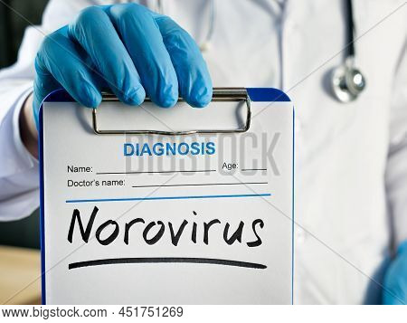 The Doctor Shows The Diagnosis Norovirus On The Form.