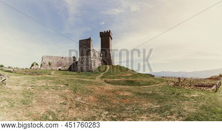 Radicofani - Italy. June 04, 2021: Panoramic View To Rocca Of Radicofani On Grass Hilltop With Vinta