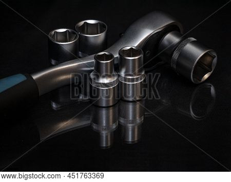 Ratchet Wrench. Set Of Stainless Steel Hex Sockets On Shiny Black Surface. Universal Professional To