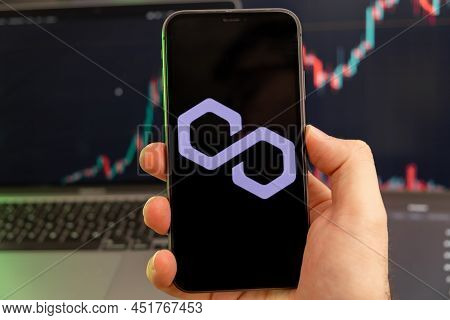 Polygon Matic Cryptocurrency Logo On The Screen Of A Smartphone In Mans Hand With A Growing Trend On