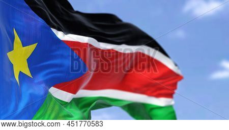Detail Of The National Flag Of South Sudan Waving In The Wind On A Clear Day. South Sudan Is A Landl