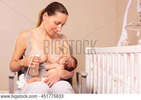 Loving Mother Breastfeed Newborn Baby And Use Breast Pump