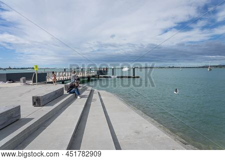 Tauranga New Zealand March 26 2022; People Sitting On Tidal Steps Watching Jumpers Leaping Off Divin