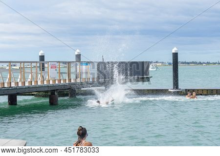 Tauranga New Zealand March 26 2022;boys Enjoy Jumping Of Pier And Diving Platform On City Waterfront