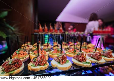 Decorated Catering Banquet Table With Different Food Snacks And Appetizers With Sandwich