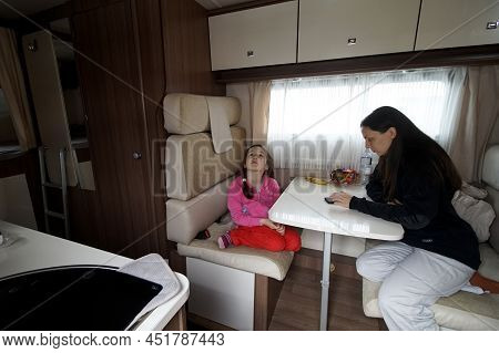 Otopeni, Romania - March 17, 2022: A Mother With Her Daughter War Refugees From Ukraine Rest In A Ca