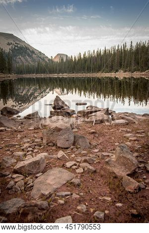 Shoreline Of Mountain Lake At Sunrise During The Summer